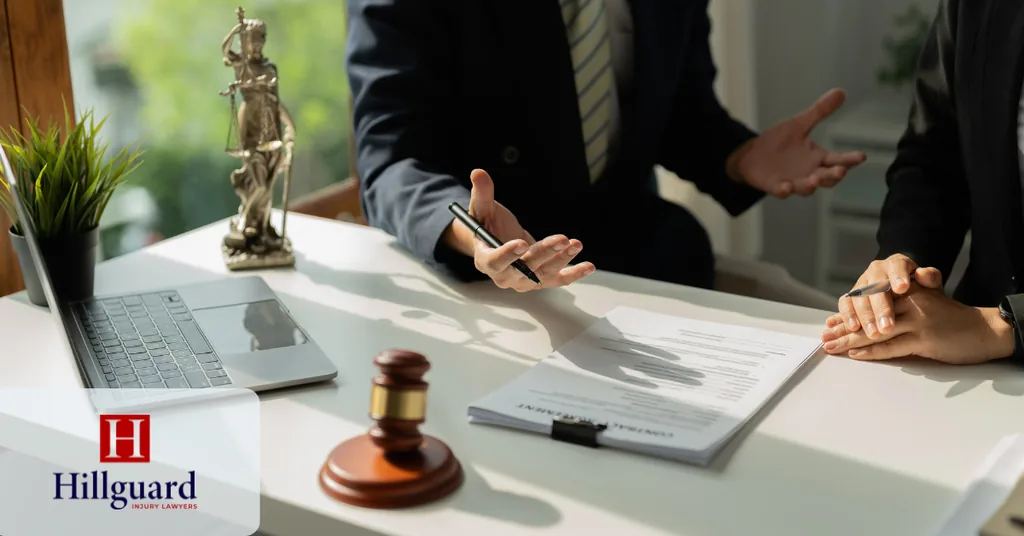 Client and attorney reviewing a fee agreement and case documents at a desk, with a gavel and scales of justice