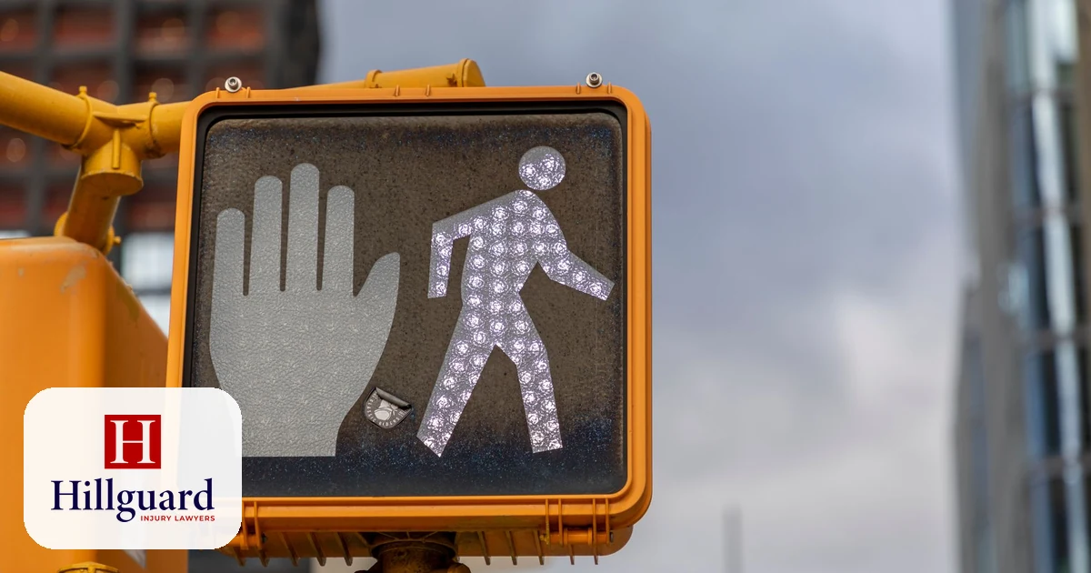 Pedestrian crossing signal showing the walk symbol at a marked California crosswalk