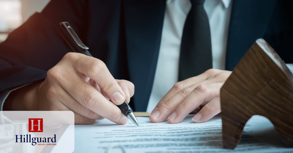 Lawyer reviewing and signing personal injury documents.
