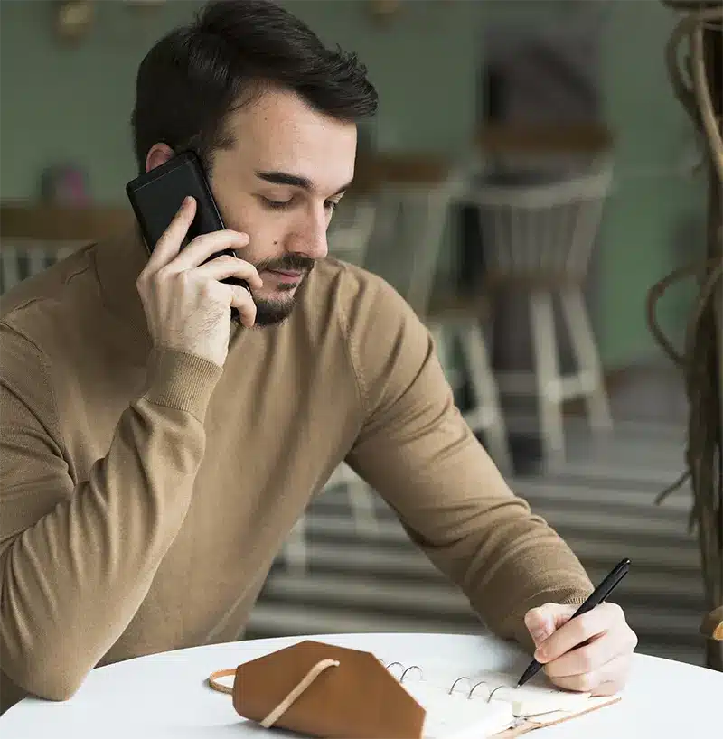 business man with agenda talking phone img