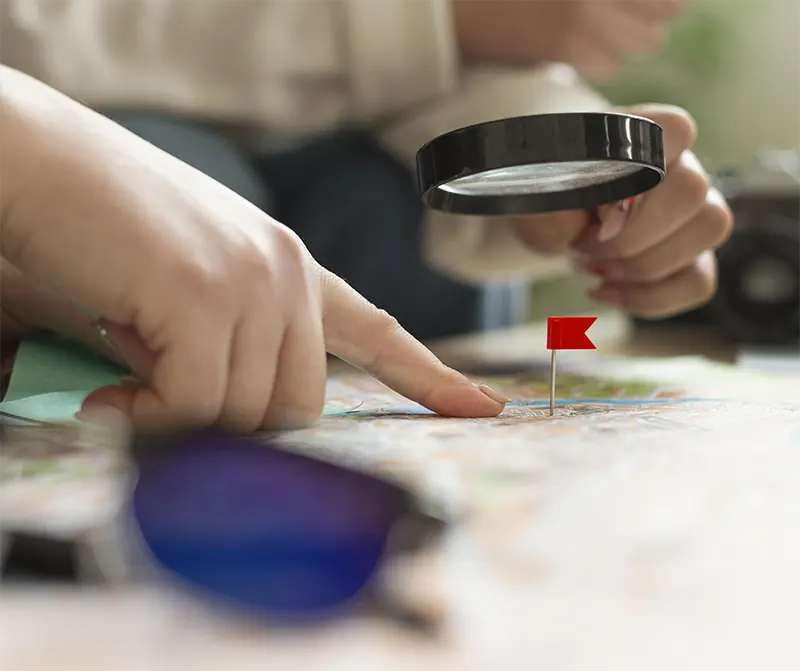 close up hand having magnifying glass img